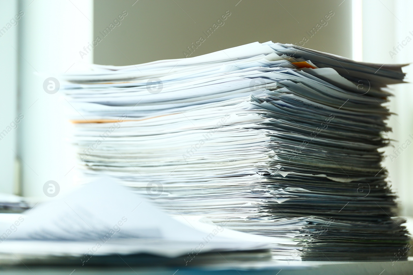 Photo of Stacks of documents on desk in office