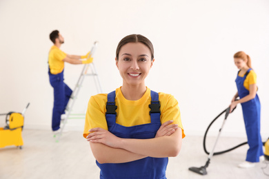 Photo of Professional janitor in uniform indoors. Cleaning service