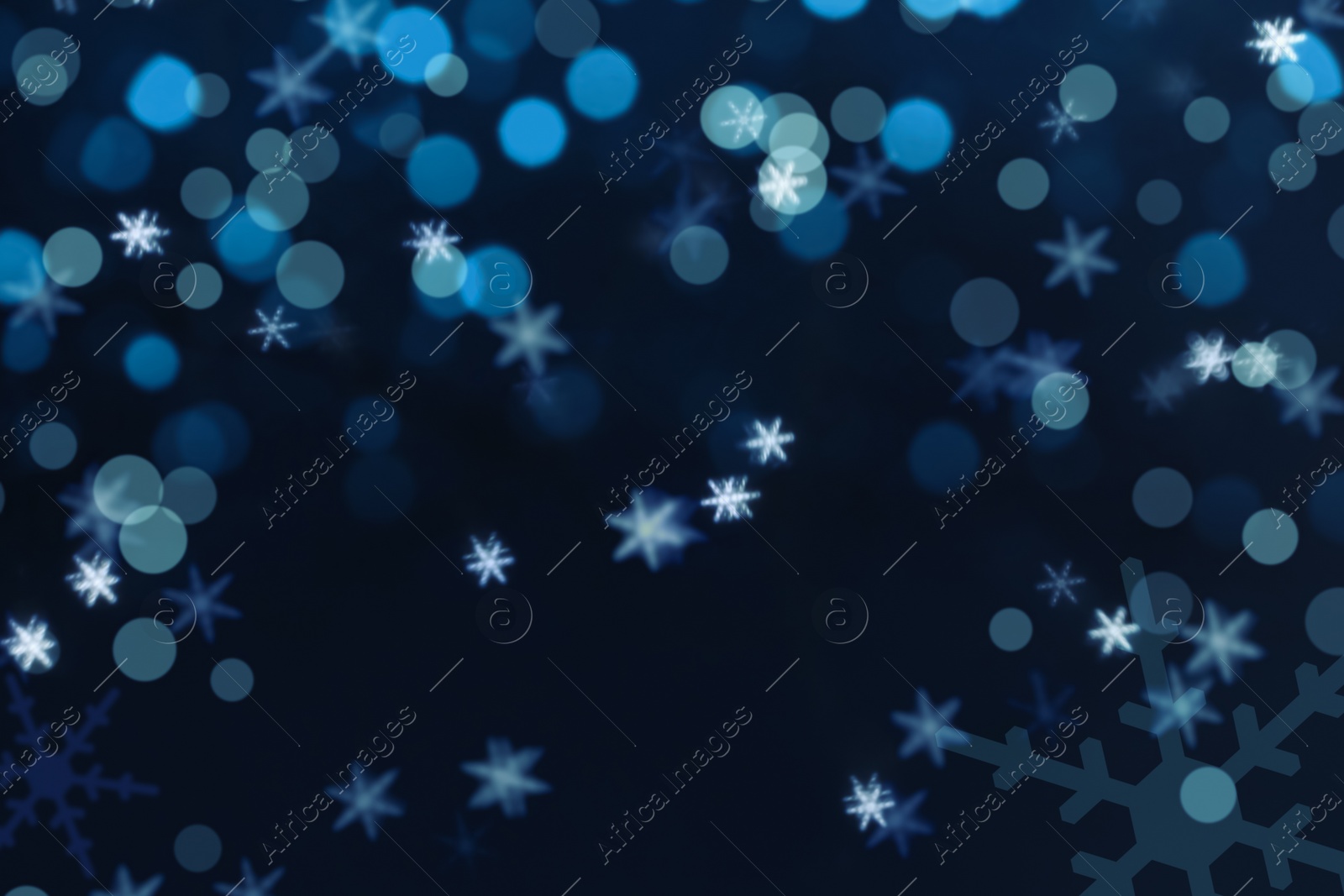 Image of Snowflakes and blurred lights on dark blue background