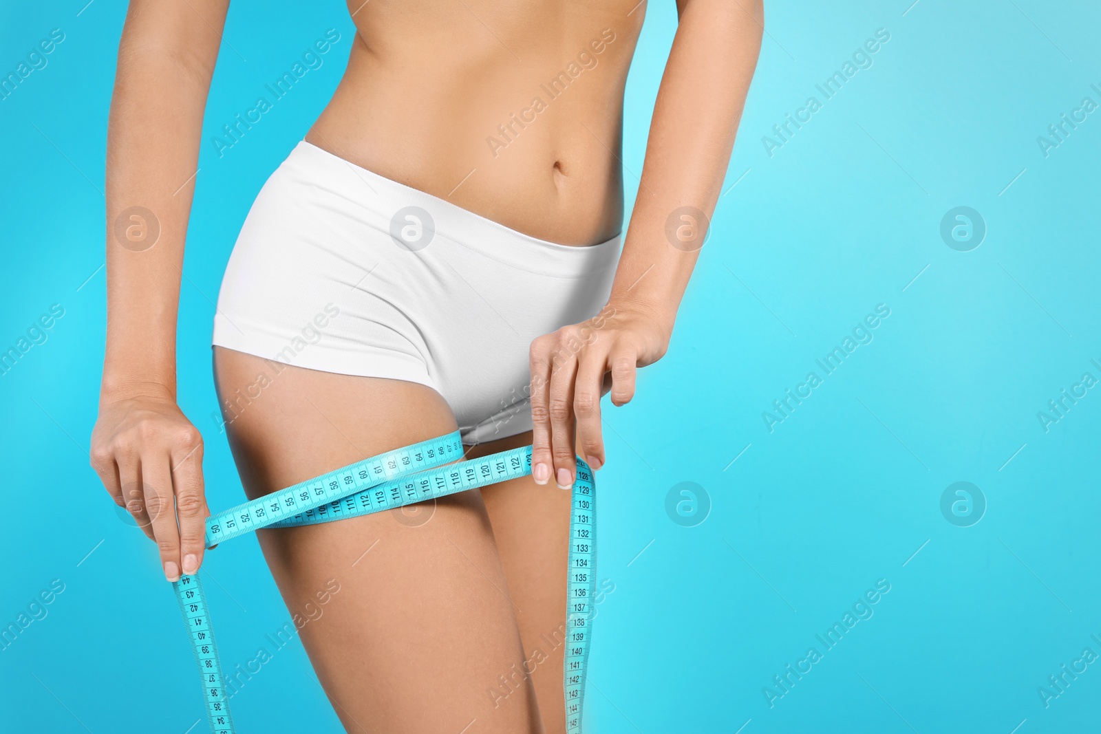 Photo of Slim woman with measuring tape on color background. Healthy diet