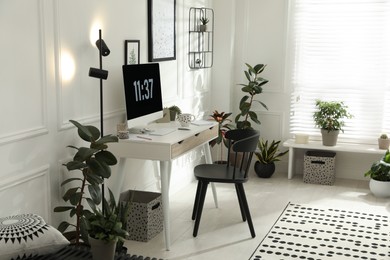 Photo of Stylish room interior with comfortable workplace. Home office