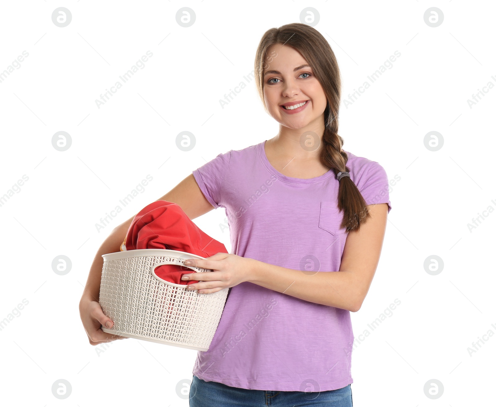 Photo of Happy young woman holding basket with laundry on white background