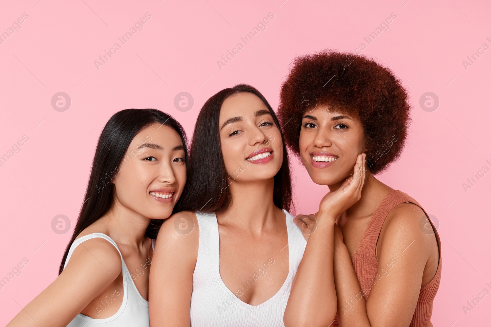 Photo of Portrait of beautiful young women on pink background