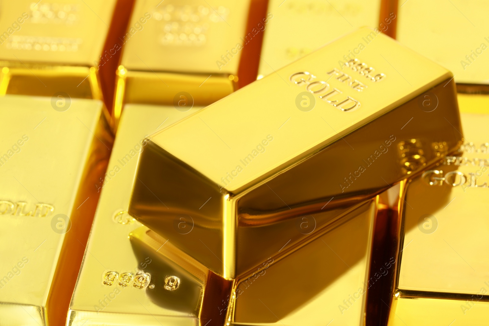 Photo of Many shiny gold bars as background, closeup