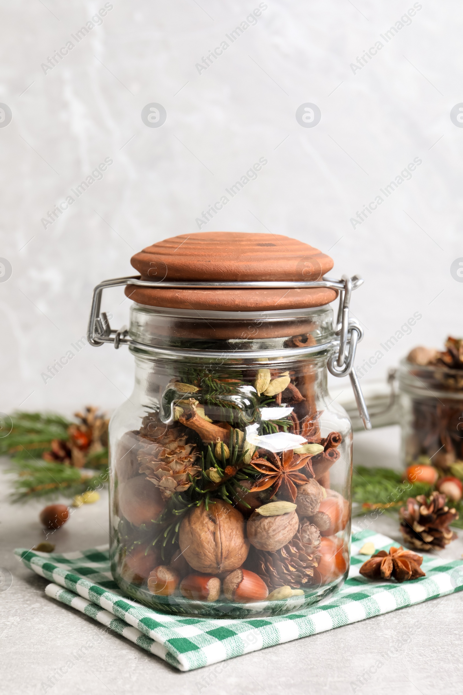 Photo of Aromatic potpourri in glass jar on white table