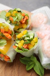 Tasty spring rolls on grey table, closeup