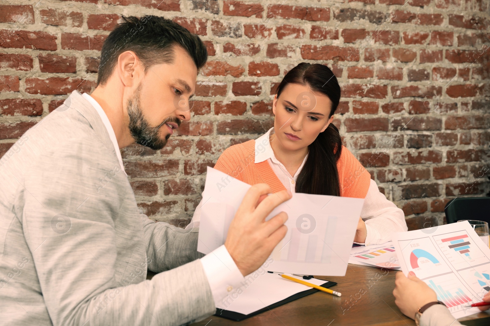 Photo of Team of employees working together in office