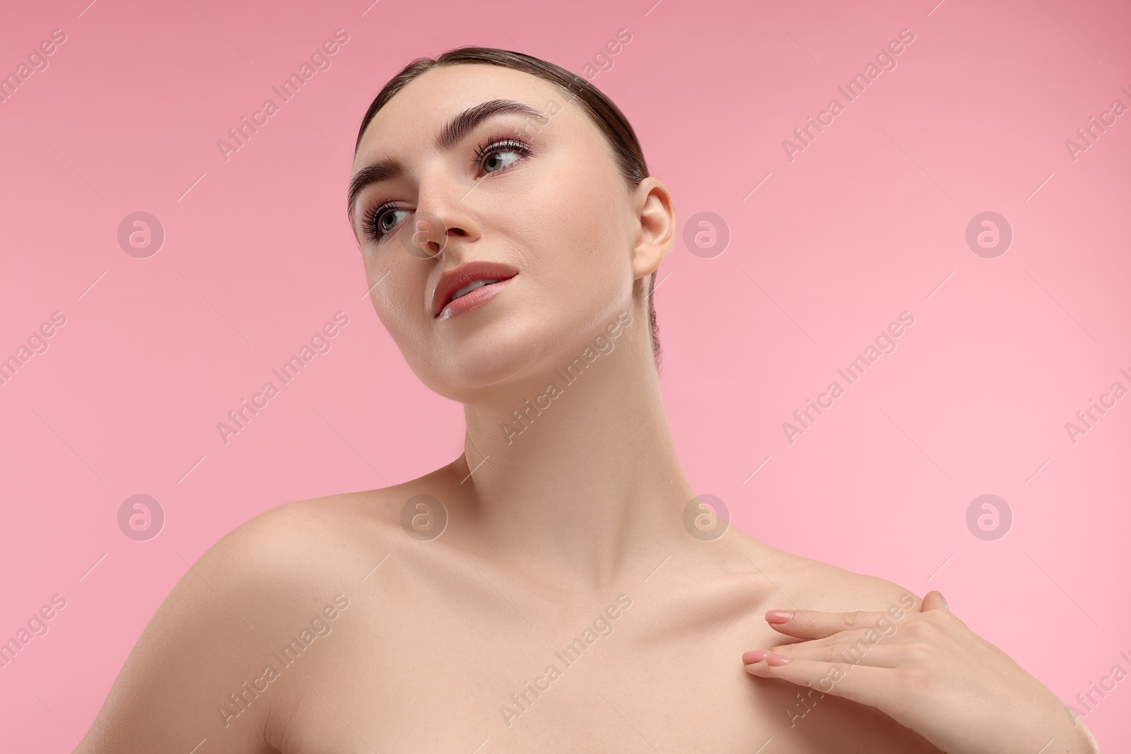 Photo of Portrait of beautiful woman on pink background