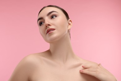 Portrait of beautiful woman on pink background