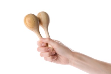 Photo of Woman holding wooden maracas on white background, closeup. Musical instrument