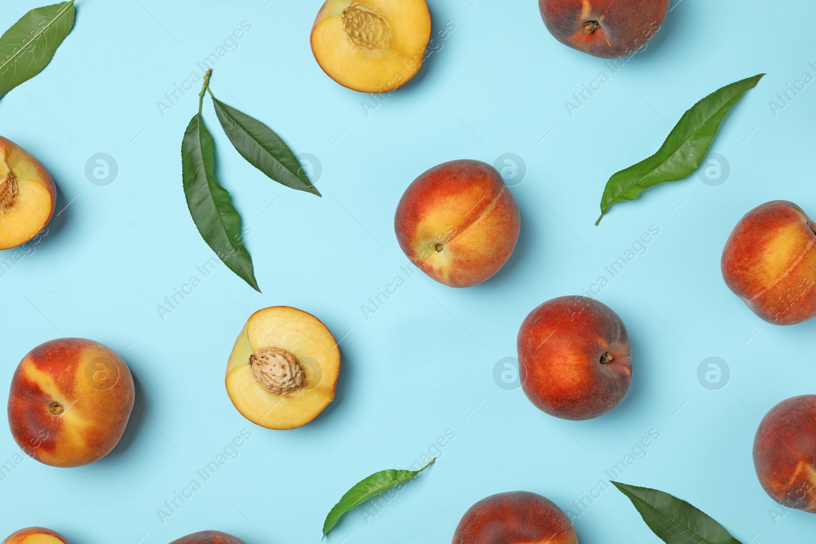 Photo of Flat lay composition with sweet juicy peaches on light blue background