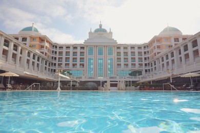 Beautiful view of hotel with swimming pool at resort