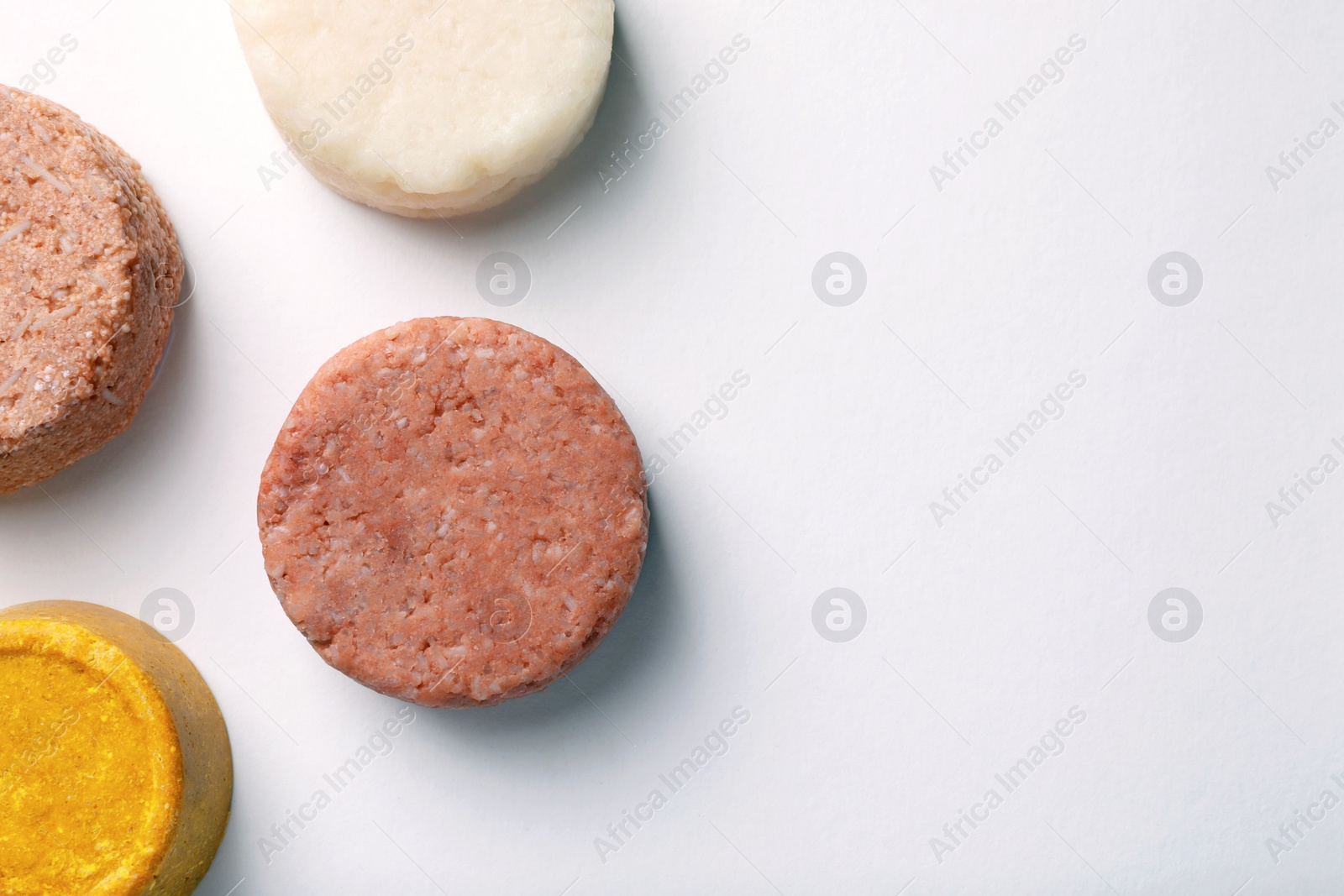 Photo of Solid shampoo bars on white background, flat lay. Space for text