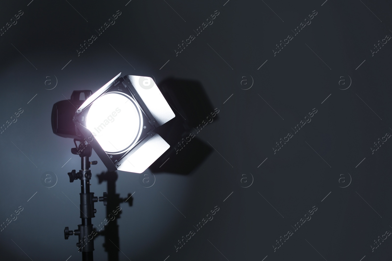 Photo of Professional photo studio lighting equipment on dark background. Space for text