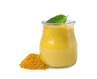 Photo of Jar with tasty curry sauce, powder and basil leaf isolated on white