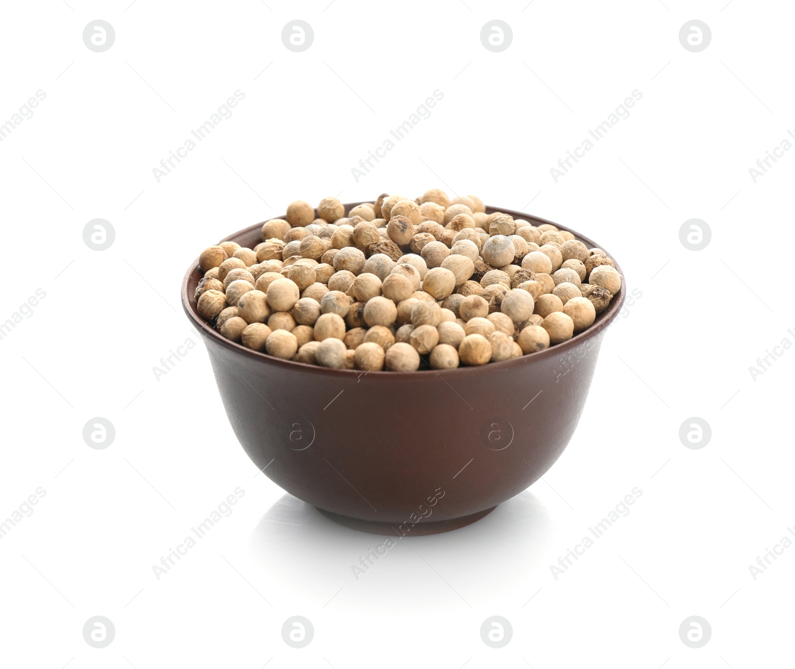 Photo of Bowl with pepper grains on white background