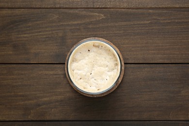 Photo of Fresh leaven on wooden table, top view