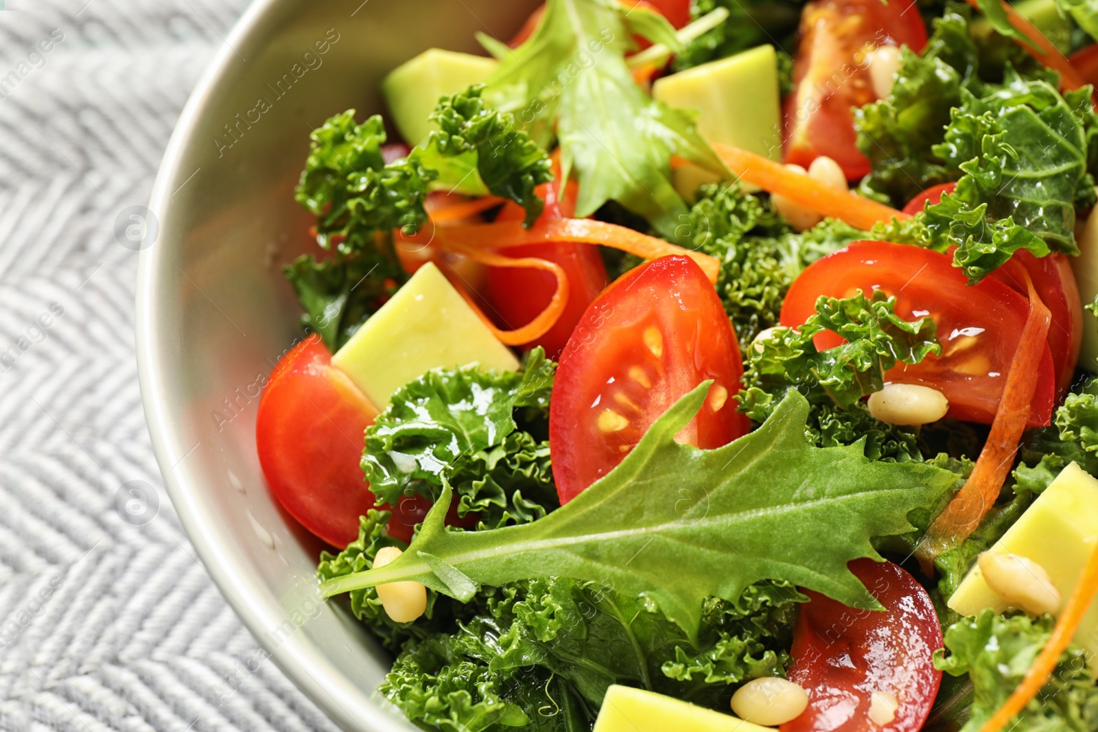 Photo of Tasty fresh kale salad on table, closeup