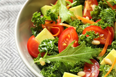 Photo of Tasty fresh kale salad on table, closeup