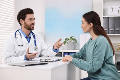 Photo of Doctor consulting patient during appointment in clinic