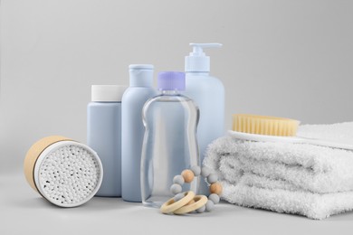 Different baby care products and accessories on light grey background