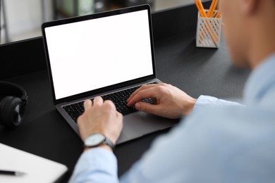 Photo of Man watching webinar at table in office, closeup