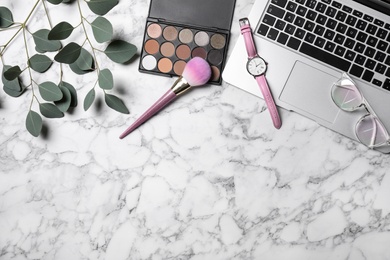 Photo of Flat lay composition with laptop and beauty blogger's stuff on marble background, space for text