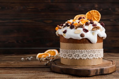 Delicious Easter cake with dried fruits and nuts on wooden table. Space for text