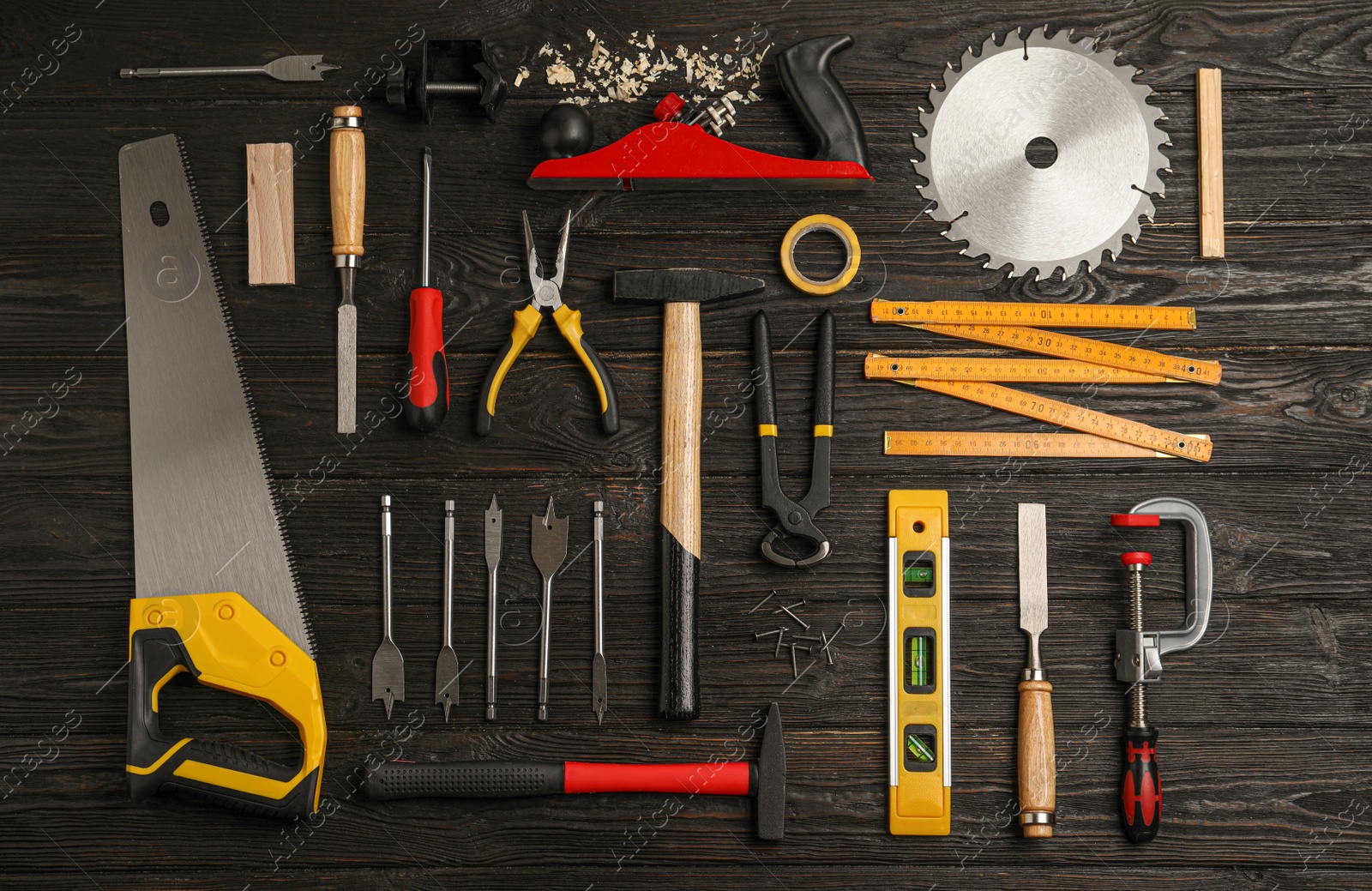 Photo of Flat lay composition with carpenter's tools on black wooden background
