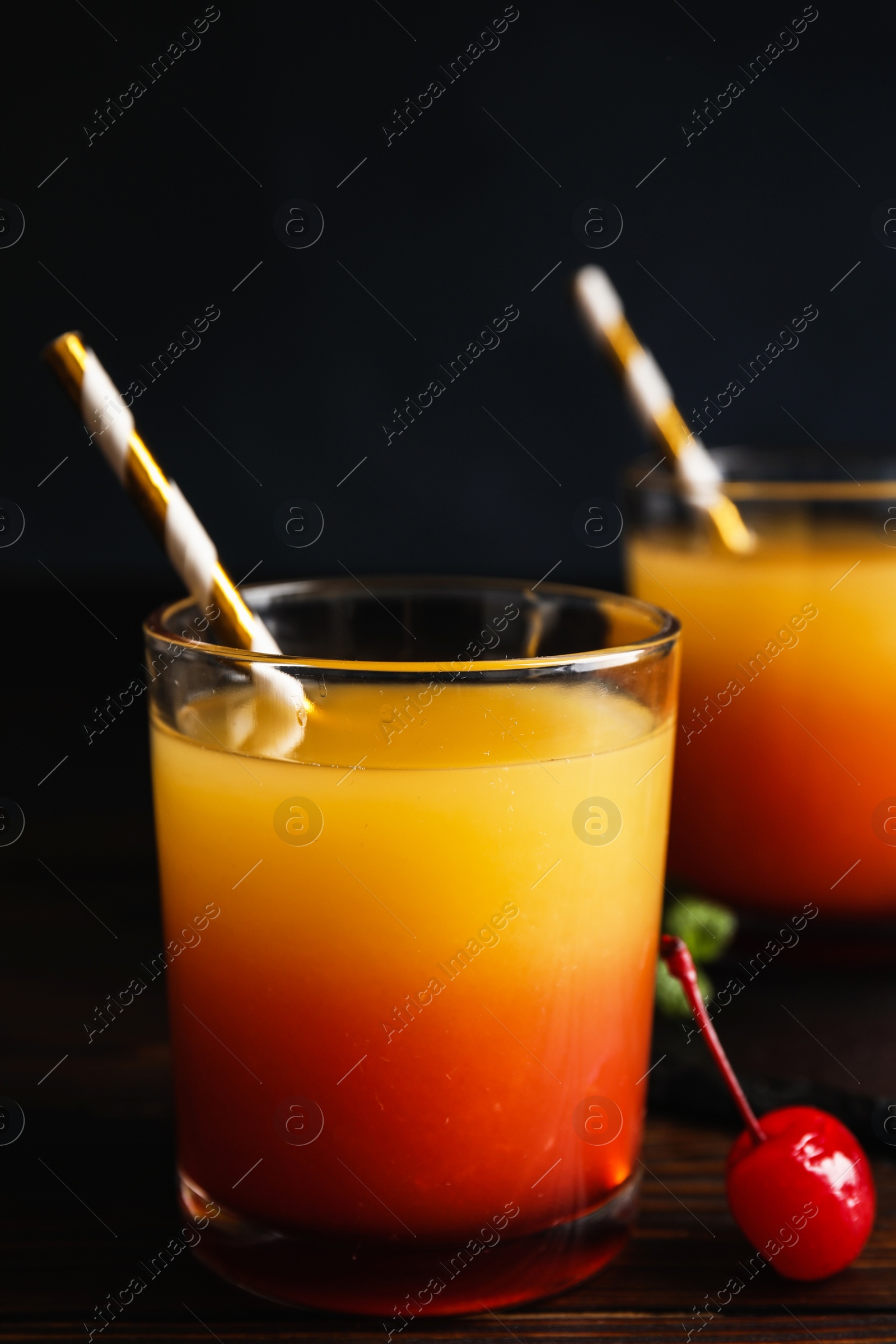 Photo of Fresh alcoholic Tequila Sunrise cocktail on wooden table