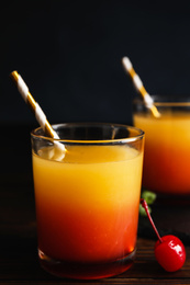 Photo of Fresh alcoholic Tequila Sunrise cocktail on wooden table