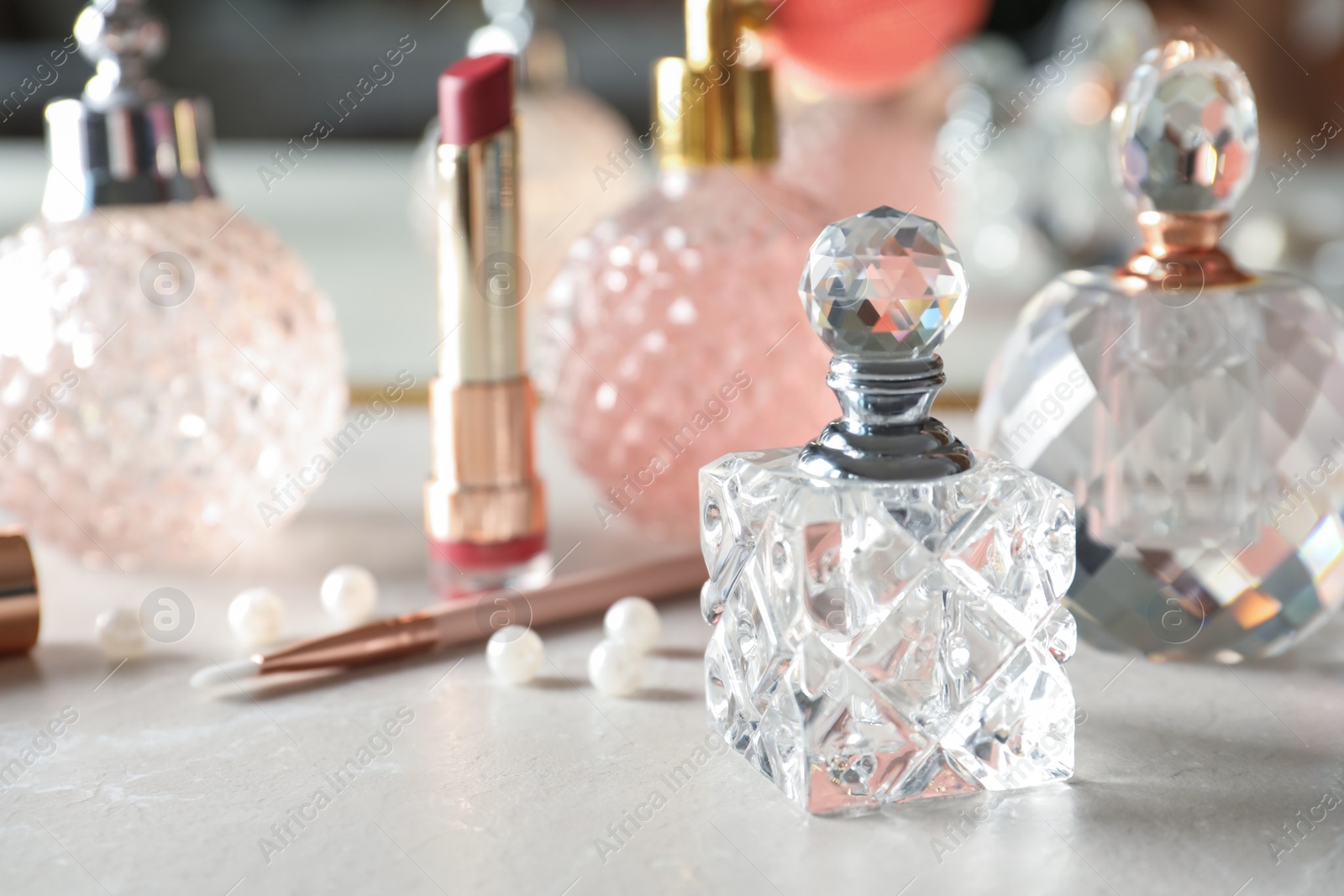 Photo of Different perfume bottles on dressing table, space for text