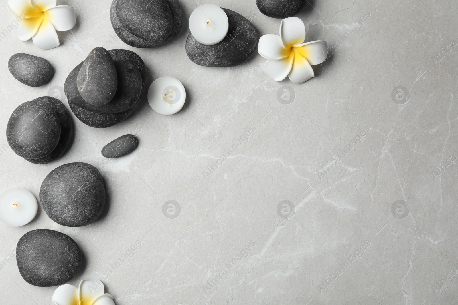 Photo of Flat lay composition with spa stones, candles and space for text on grey background