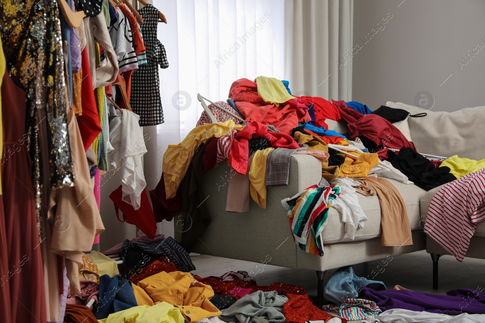 Photo of Mess of clothes all over room. Fast fashion