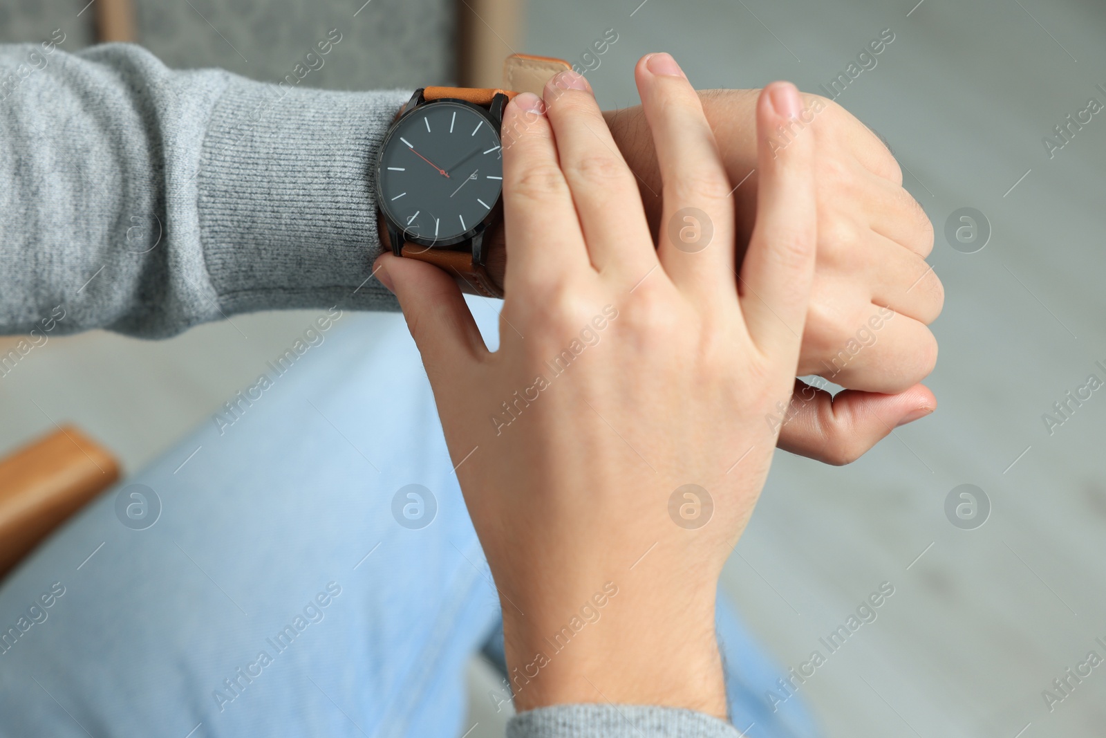 Photo of Man checking time in room, closeup. Being late