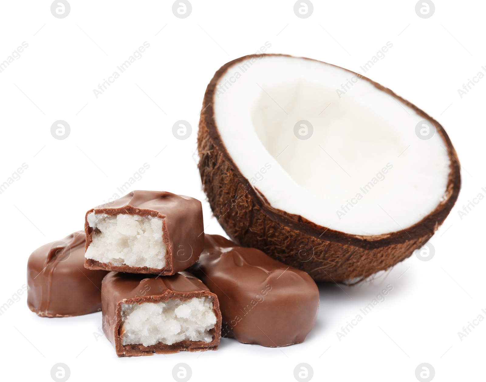 Photo of Delicious milk chocolate candy bars with coconut filling on white background