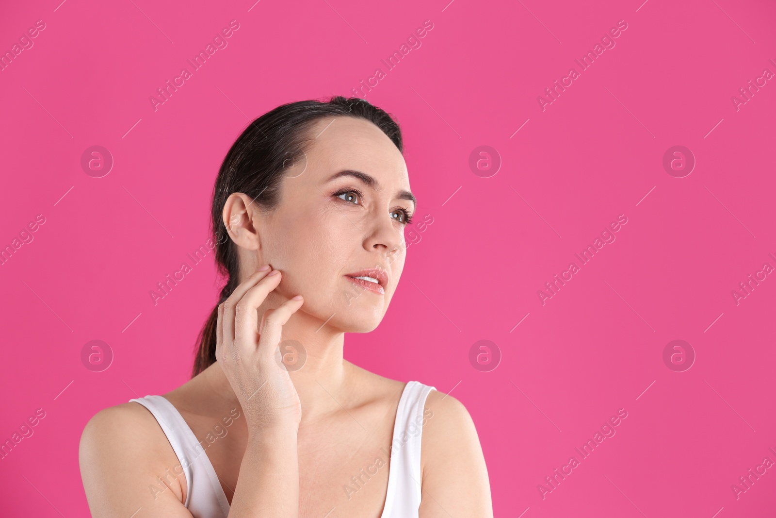 Photo of Portrait of beautiful mature woman on pink background