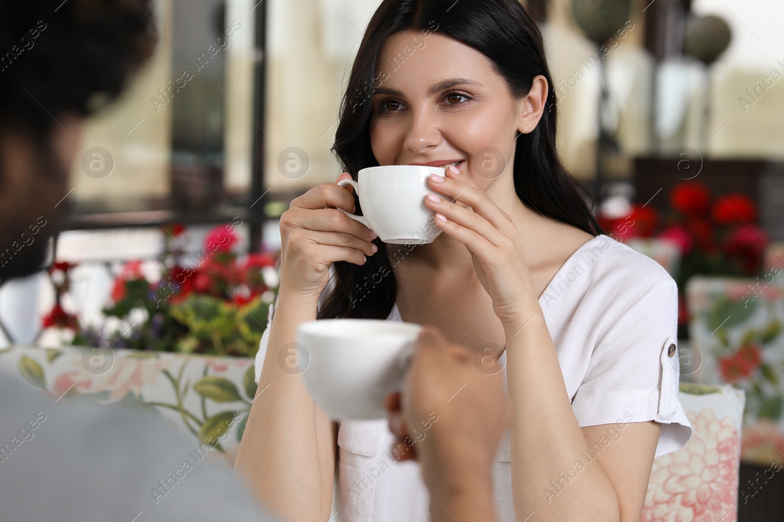 Photo of International dating. Lovely couple enjoying tasty coffee in cafe