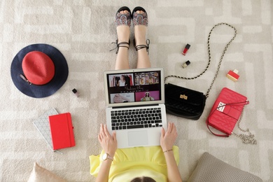 Woman and laptop with fashion blogger site on floor, top view