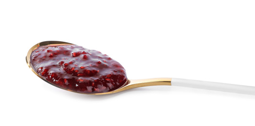 Photo of Delicious raspberry jam in wooden spoon isolated on white
