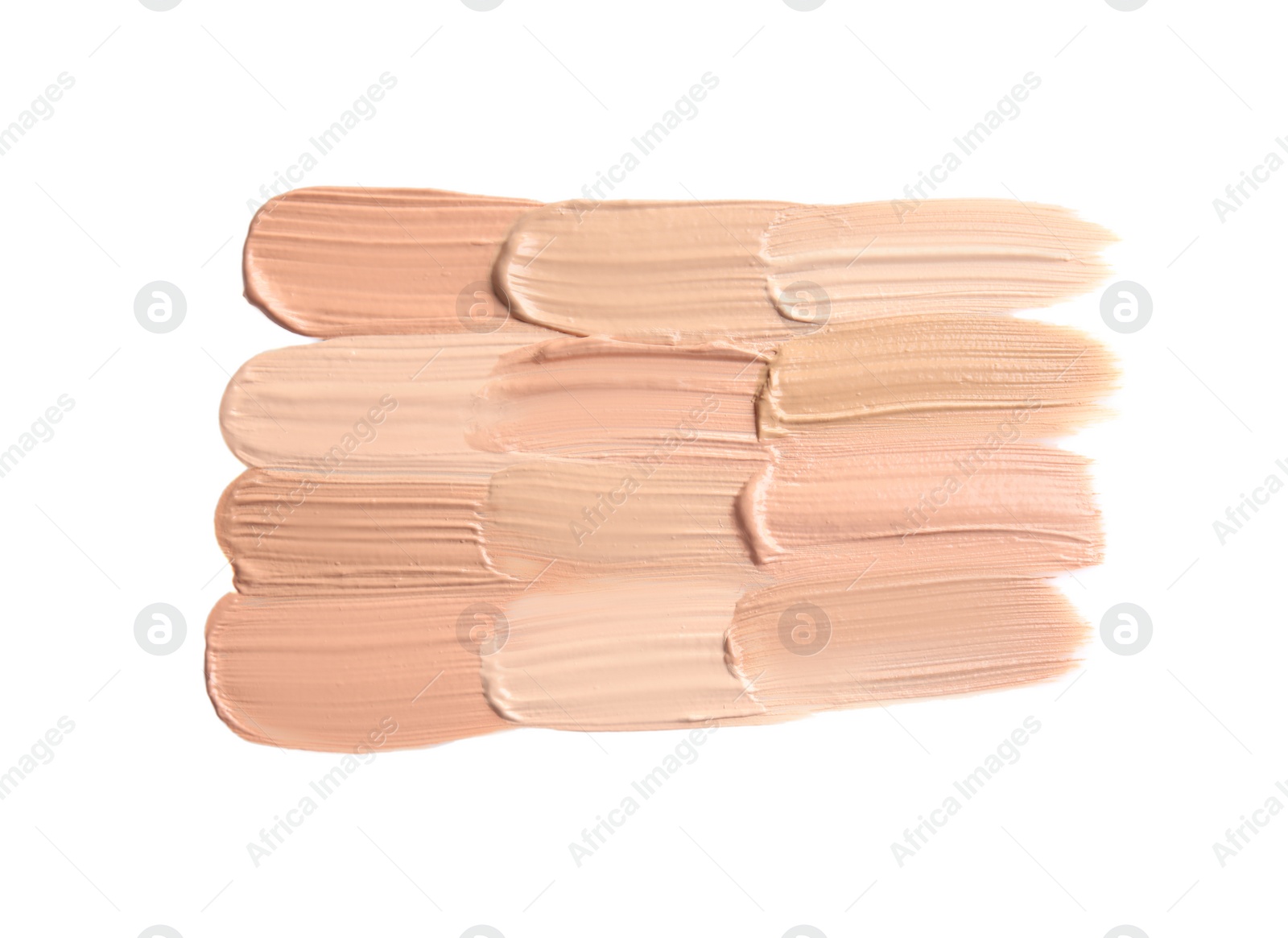 Photo of Samples of different foundation shades on white background, top view