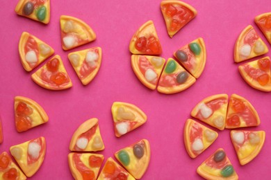 Photo of Tasty jelly candies in shape of pizza on pink background, flat lay