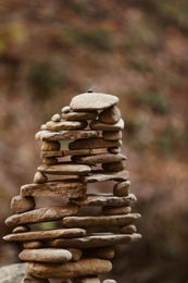 Photo of Tower of stones against blurred background. Life balance