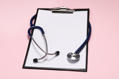 Stethoscope and clipboard on pink background. Medical tool