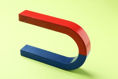 Photo of Red and blue horseshoe magnet on color background