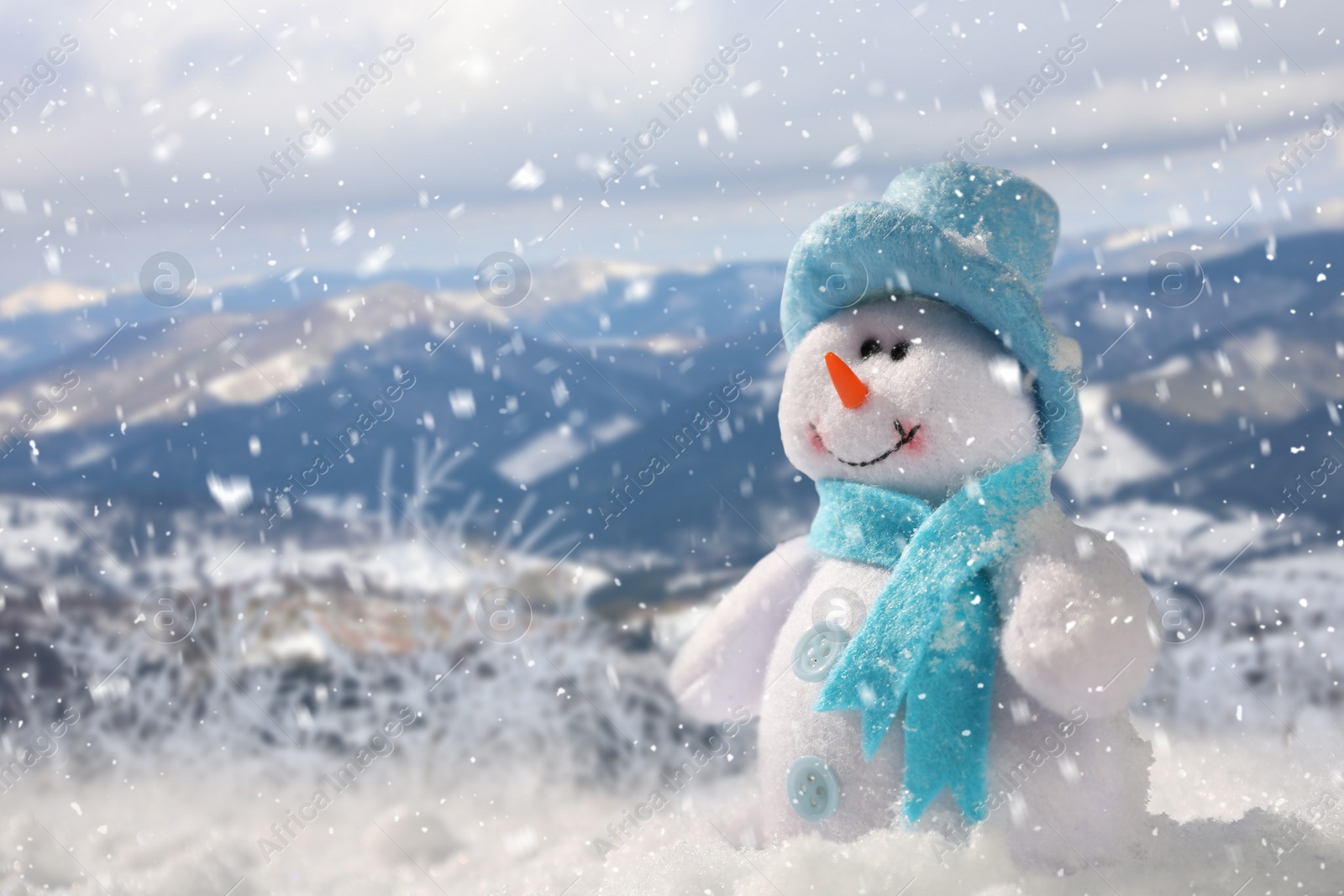 Image of Cute small decorative snowman outdoors on sunny day, space for text