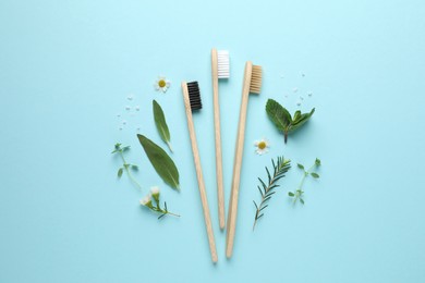 Photo of Bamboo toothbrushes, beautiful chamomile flowers, sea salt and herbs on turquoise background, flat lay