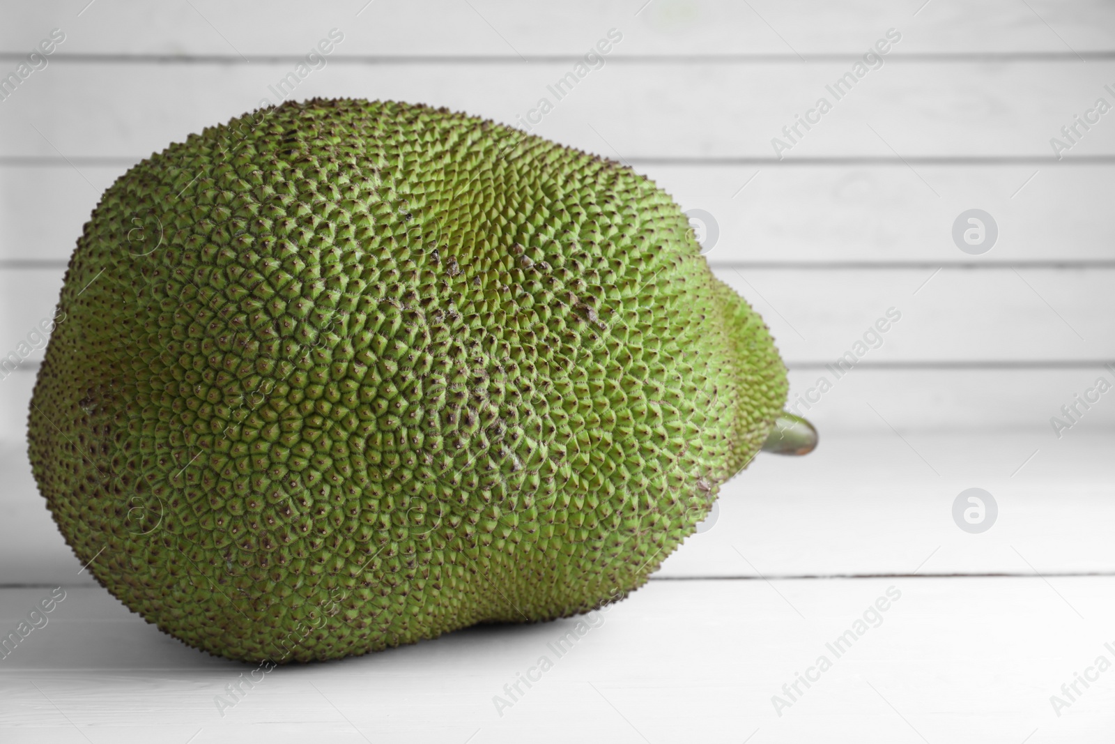 Photo of Delicious fresh exotic jackfruit on white table