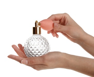 Photo of Woman holding bottle of luxury perfume on white background, closeup