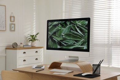 Photo of Comfortable workplace with modern computer near window in room